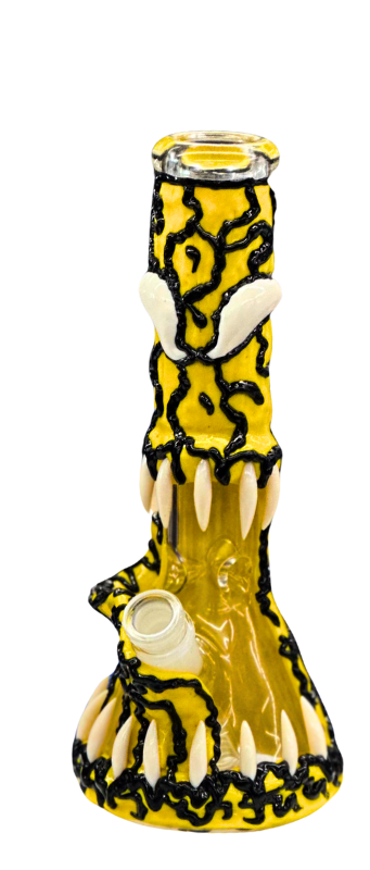 A yellow glass bong with black and white decorative elements, including fang-like features near the base and top, available at Vape World GA in Athens.